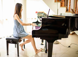 Teenage girl playing new high-end grand piano