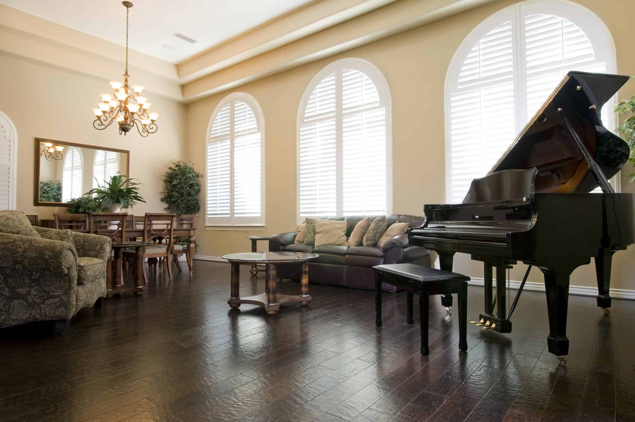 Upscale living room in Utah with one of the best baby grand pianos on display next to a couch